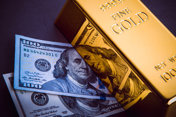 A bar of gold and a hundred-dollar bills.