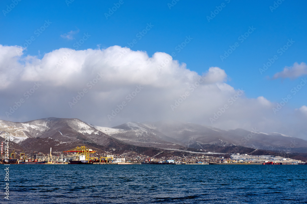 Clouds over snow-capped mountains and sea