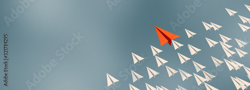 3D illustration of leadership success business concept rocket paper fly over color background lead rocket stand out of other paper rocket follower photo