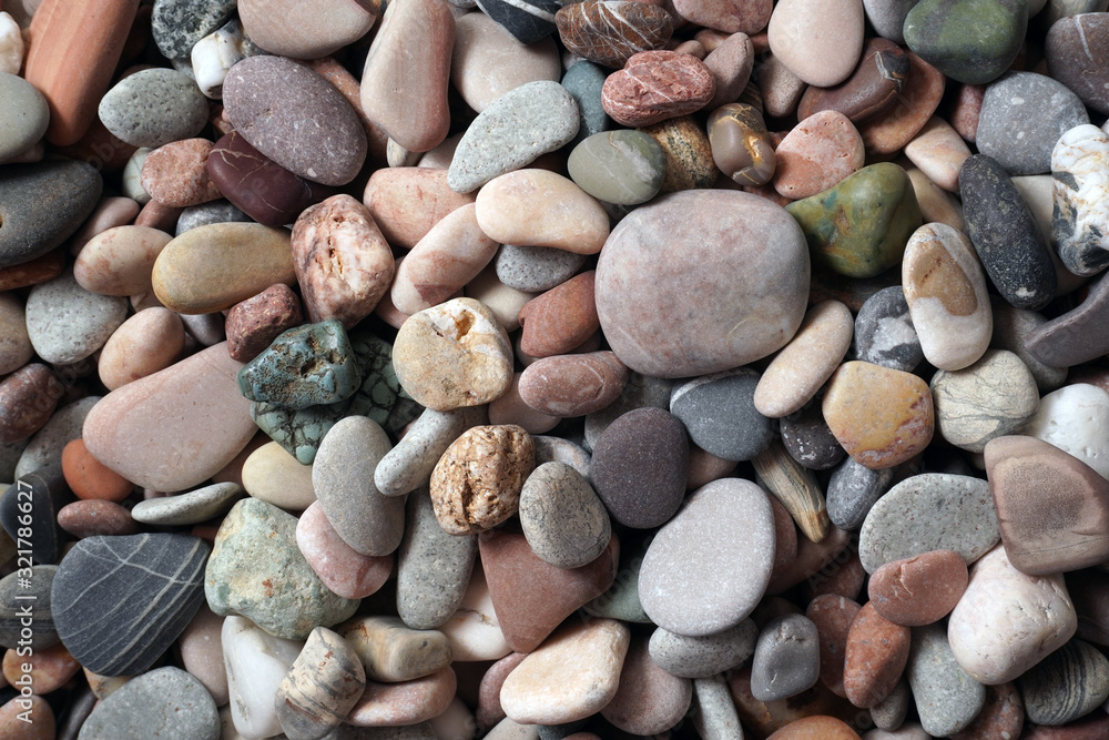 Gravel pattern of colored stones with shell. Abstract nature pebbles background.Small sea stones on the beach, vacation at sea. Top view Gravel pattern of colored stones with shell. Abstract nature pebbles background.Small sea stones on the beach, vacation at sea. Top view