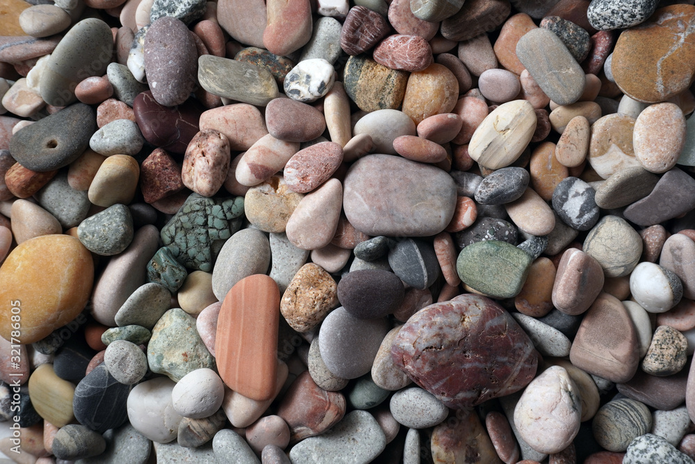 Gravel pattern of colored stones with shell. Abstract nature pebbles background.Small sea stones on the beach, vacation at sea. Top view Gravel pattern of colored stones with shell. Abstract nature pebbles background.Small sea stones on the beach, vacation at sea. Top view