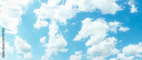 Blue sky background. Heaven peace tranquility. White clouds sunlight. Summer day.