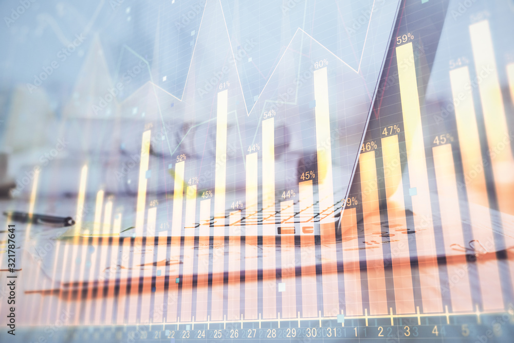 Forex Chart hologram on table with computer background. Double exposure. Concept of financial markets. Forex Chart hologram on table with computer background. Double exposure. Concept of financial markets.