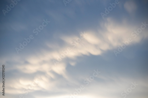 Fototapeta Naklejka Na Ścianę i Meble -  natural moving white cloud on blue sky in evening.  strange cloud movement background.