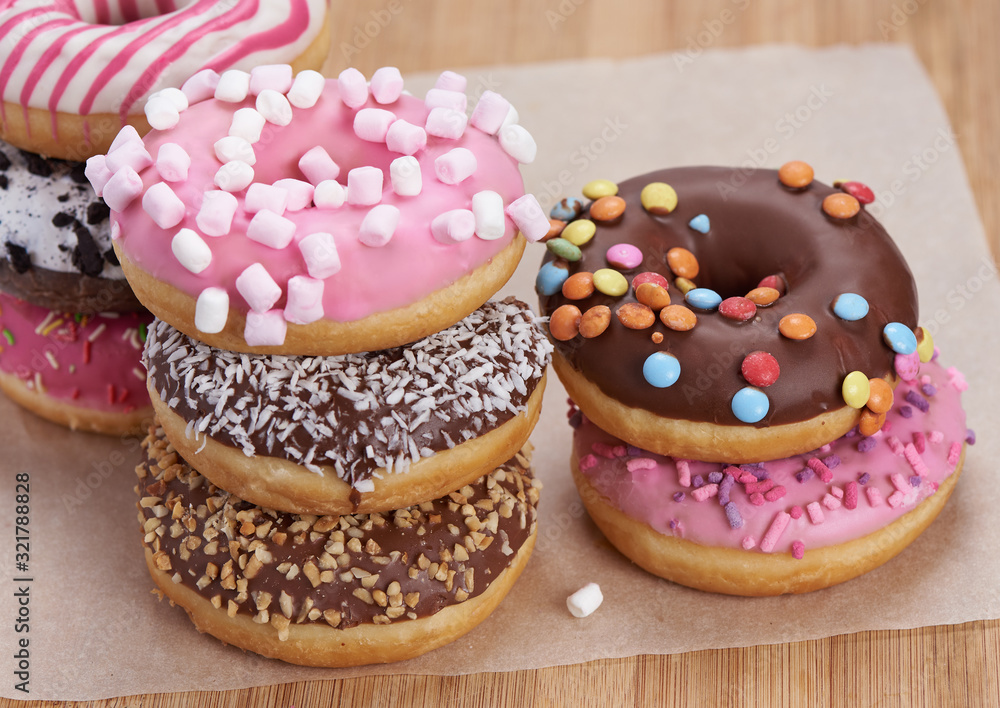heap of colorful doughnuts on a table heap of colorful doughnuts on a table