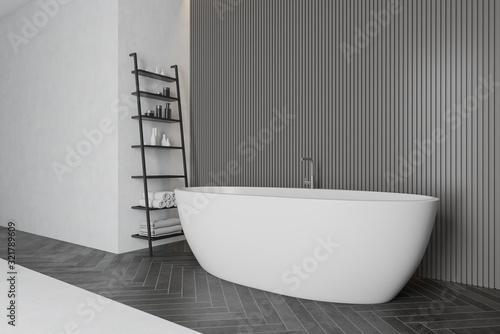 Gray bathroom corner with tub and shelves