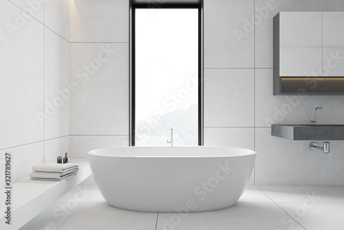 White tile bathroom interior  tub and sink