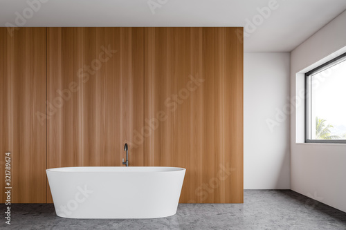 White and wooden bathroom interior with tub
