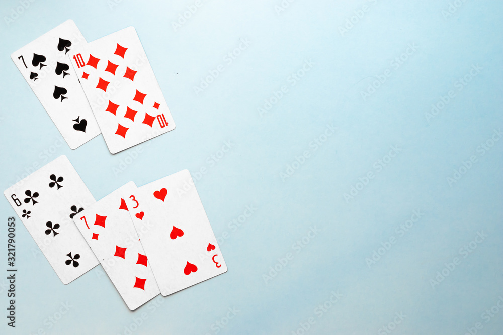 Obraz premium Deck of playing cards on blue background copy space