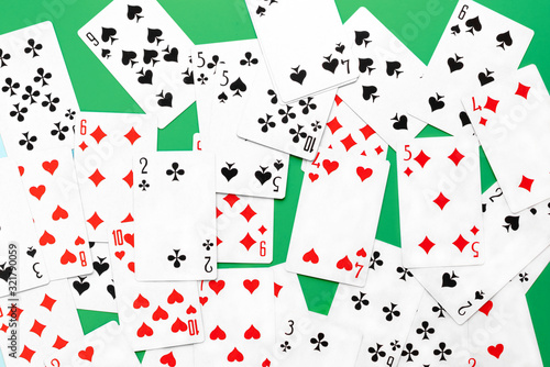 Deck of playing cards on green background