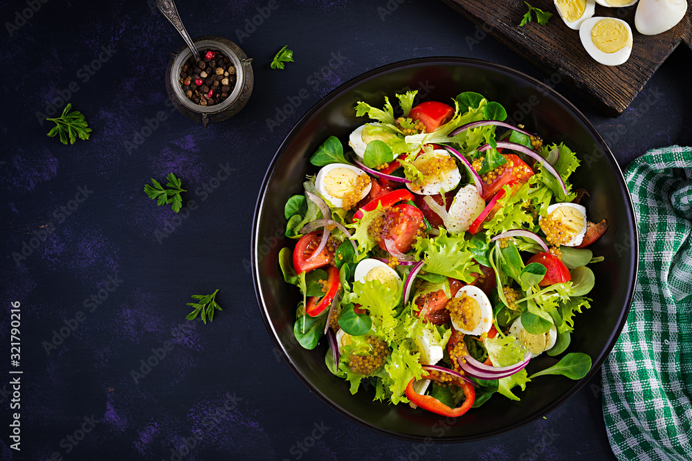 Fresh salad with vegetables tomatoes, red onions, lettuce and quail eggs. Healthy food and diet concept. Vegetarian food. Top view, overhead Fresh salad with vegetables tomatoes, red onions, lettuce and quail eggs. Healthy food and diet concept. Vegetarian food. Top view, overhead