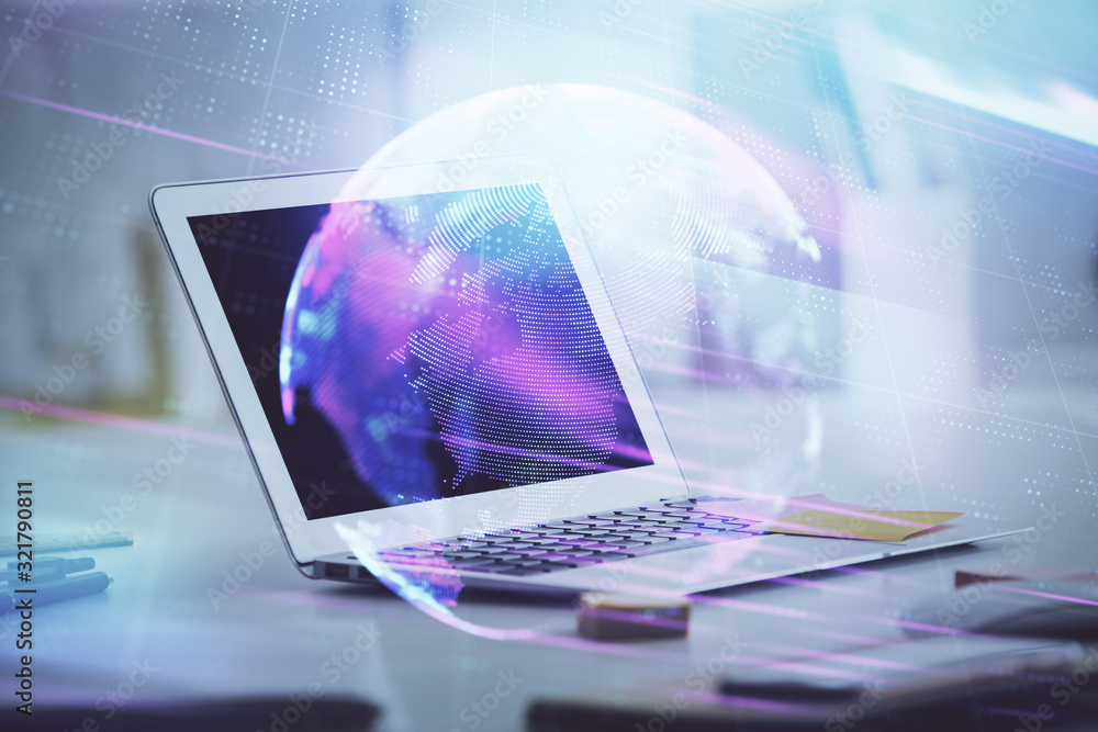 Computer on desktop in office with technology theme hologram. Multi exposure. Tech concept. Computer on desktop in office with technology theme hologram. Multi exposure. Tech concept.