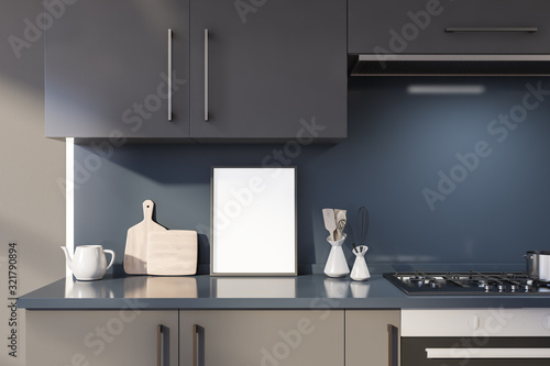 Poster on gray countertop in blue kitchen photo