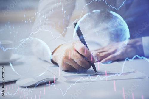 Financial trading chart multi exposure with man desktop background.