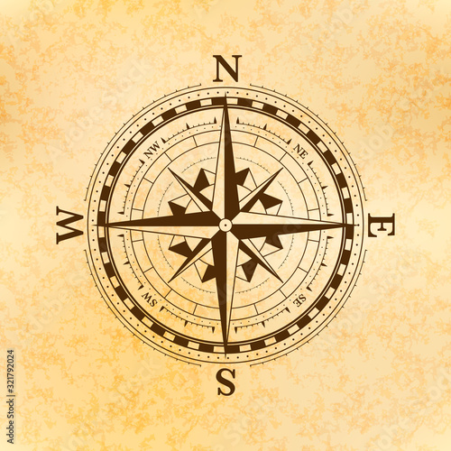 Vintage wind rose symbol, ancient compass icon on old yellow paper