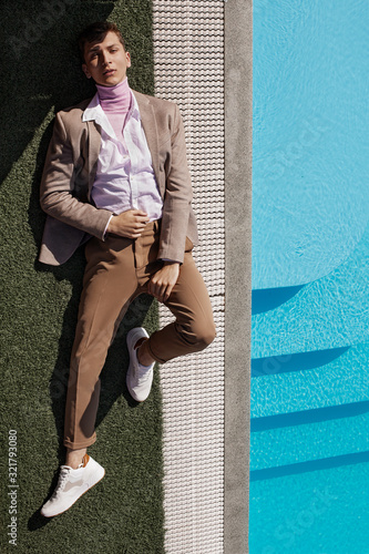  A guy in a brown suit by the pool