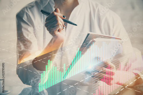 Financial chart drawn over hands taking notes background. Concept of research. Multi exposure