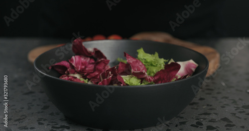 man preparing mix salad with mixed leaves