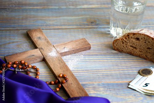 Prayer almsgiving fasting Ash Wednesday concept with wooden cross photo