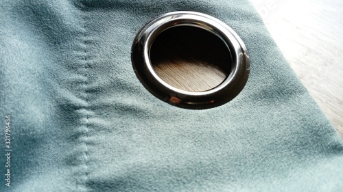 Billede på lærred Metal grommet on a gray-blue velvet curtain