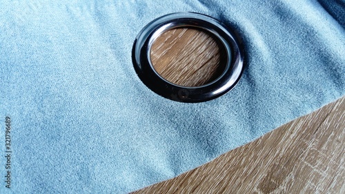 Εκτύπωση καμβά Metal grommet on a gray-blue velvet curtain