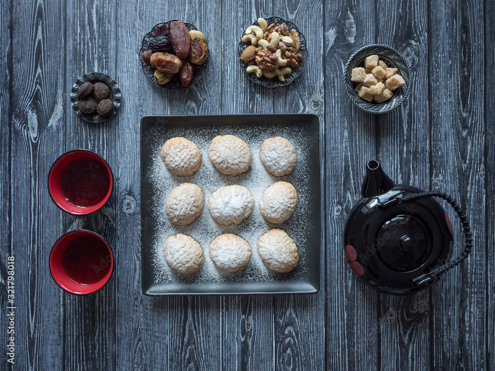 Handmade Ramadan sweets are served with tea on the table. Egyptian cookies 