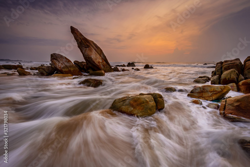 Sounthern coast of Vietnam, Binh Thuan sand, waves and rocks at the beach photo