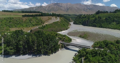 4k panning hovering 180 degree panoramic aerial view of the Rakaia bridge and Rakaia river in slight flood on the canterbury plains near Mt Hutt ski fields,Canterbury,Christchurch,New Zealand  photo