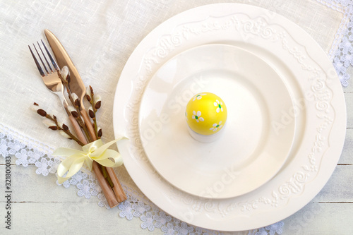Elegant empty white plate, cutlery on linen napkin