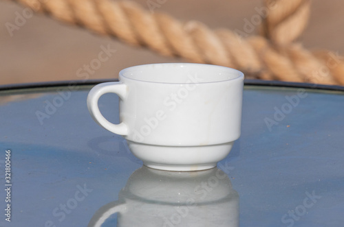 white with a handmade saucer for tea on a street table