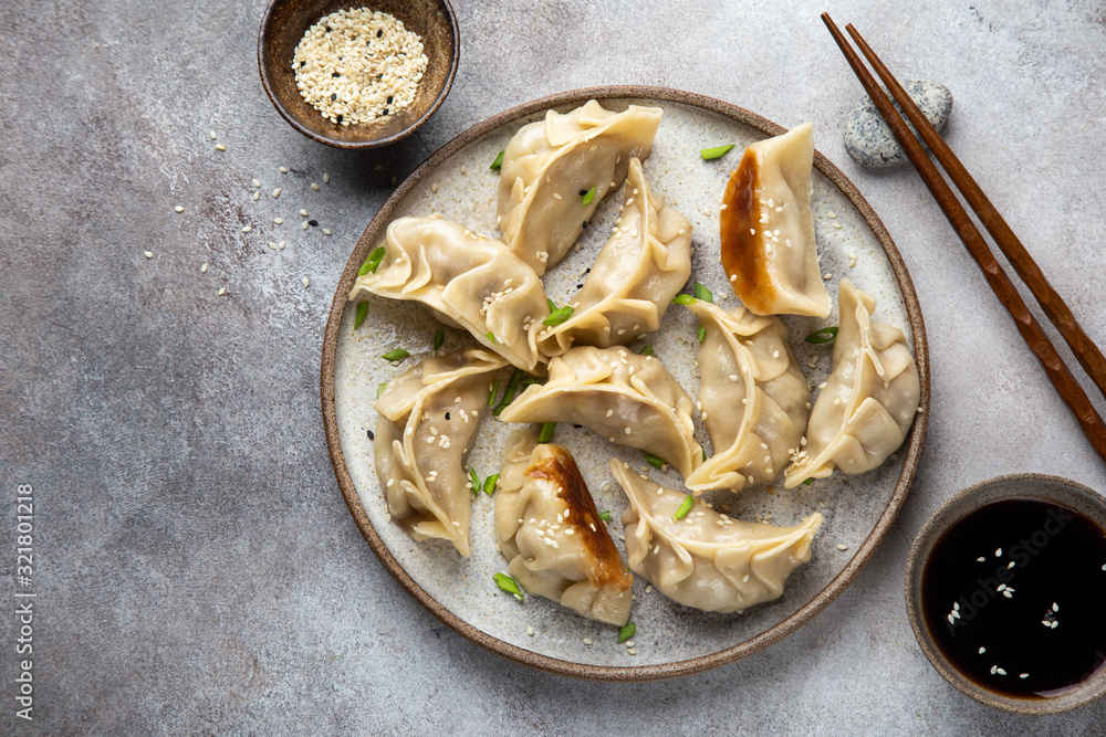 Traditional japaneese gyoza dumplings with meat and mushrooms on ceramic plate Traditional japaneese gyoza dumplings with meat and mushrooms on ceramic plate