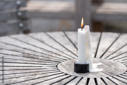 Still life of garden lighting candles on wooden table