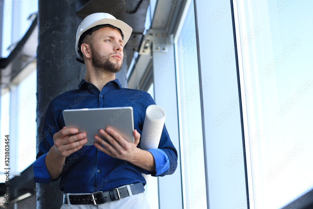Shot of a engineer using a digital tablet on a construction site. This software help me to keep track of everything. Shot of a engineer using a digital tablet on a construction site. This software help me to keep track of everything.