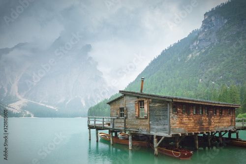 Rainy landscape of Italian mountain lake. Wooden shelter at Lago di Braies.  © Tomasz