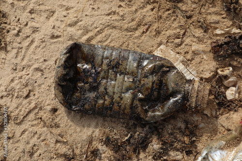 a waste plastic bottle with waste oil © leo morgen