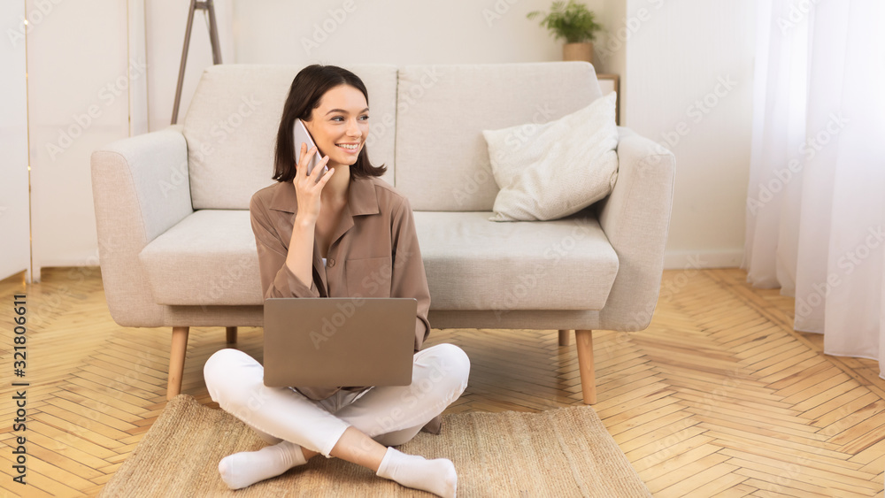 Young woman talking on mobile phone on the floor Young woman talking on mobile phone on the floor