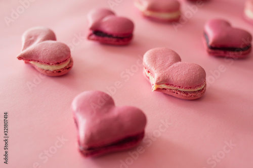 Many pink macaroons in the heart shape