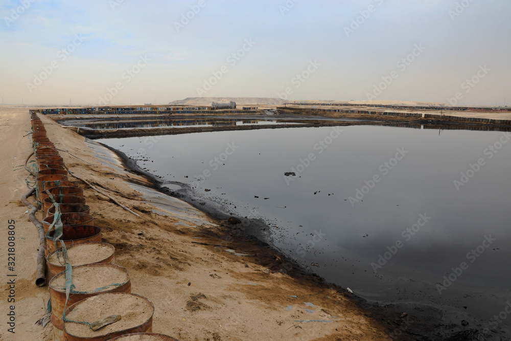 Waste oil drying field where industrial oil waste is dumped for evaporation