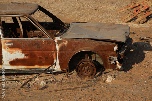 Old rusted car in desert