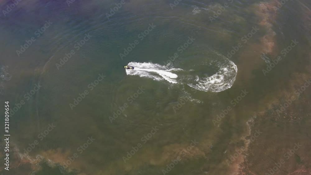 Jetski roaring across the open waters of The Mediterranean Sea, Aerial follow footage. Jetski roaring across the open waters of The Mediterranean Sea, Aerial follow footage.