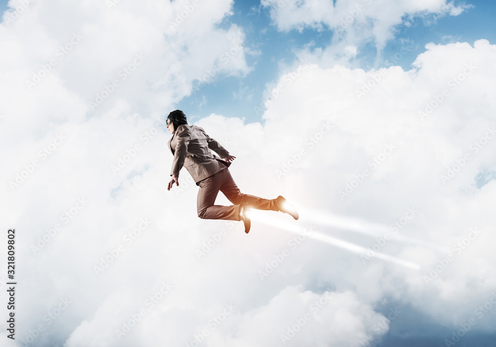 Businessman in suit and aviator hat flying in sky Businessman in suit and aviator hat flying in sky