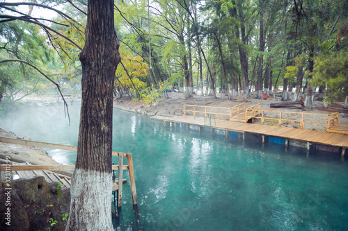 Thermal lagoon under deep sky , Blurred photo of morning fog over a lake in cold autumn weather in San Luis Potosi