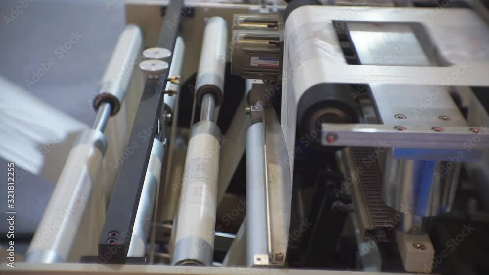 Automatic plastic bag making machine. Moving rollers with polyethylene. The concept of production, processing and automation of technological equipment. 1920 X 1080 Full Hd. Automatic plastic bag making machine. Moving rollers with polyethylene. The concept of production, processing and automation of technological equipment. 1920 X 1080 Full Hd.