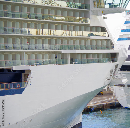 Bow with balcony cabins or staterooms of modern cruiseship or cruise ship liner Celebrity Reflection in port of Barcelona in Spain photo