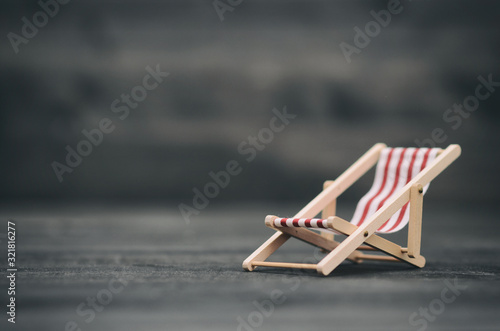 Folding Canvas Sun Lounging chair on black wooden background