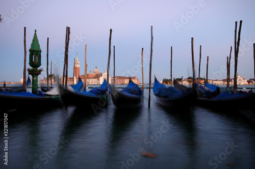 Long exposure view of gondolas and San Giorgio Maggiore across the Grand Canal, Venice, Italy © Corgarashu