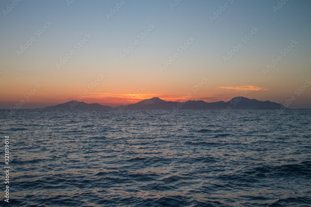 Kos island. Sunset on the background of mountains.