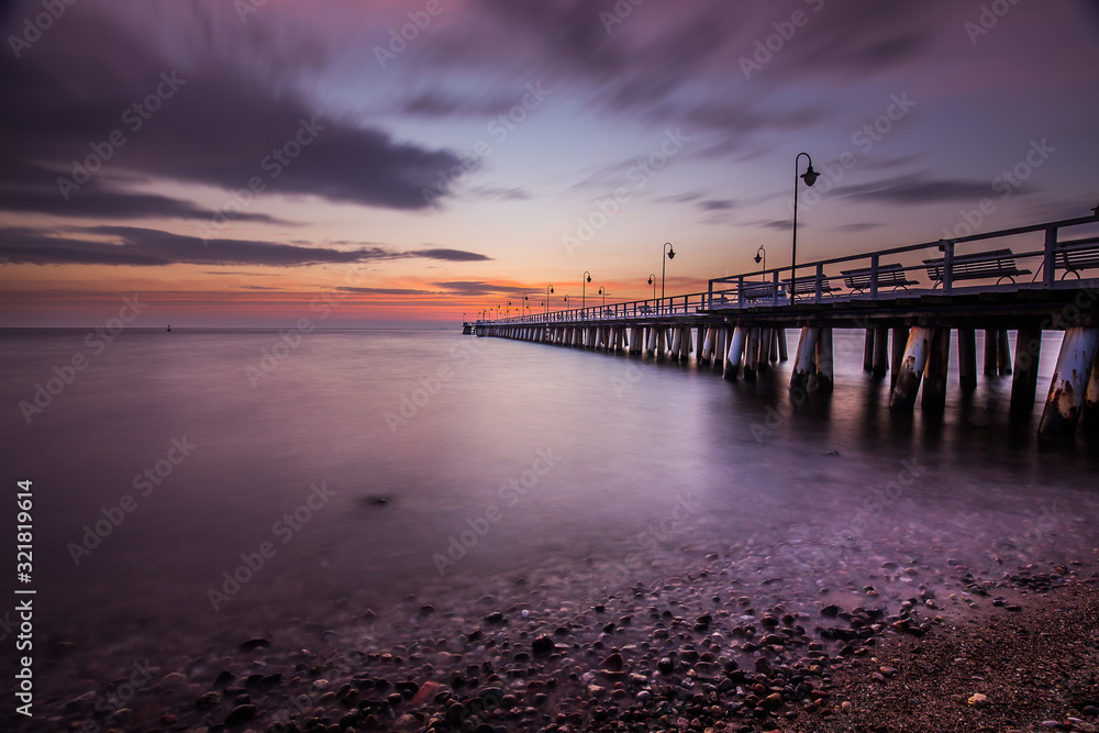 Amazing sunrise over wooden pier in Gdynia Orlowo.