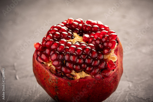 Fresh pomegranate on dark surface photo