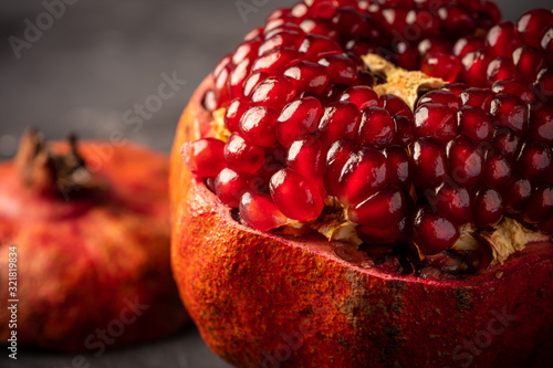 Fresh pomegranate on dark surface